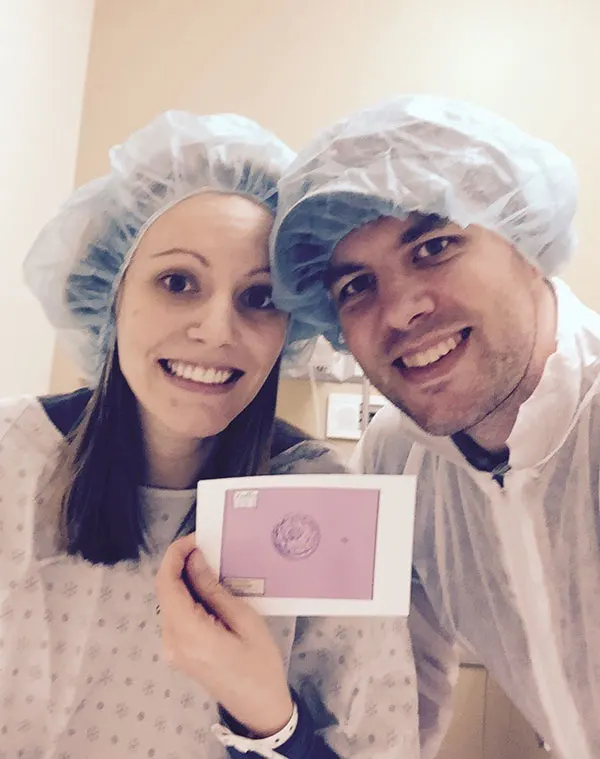 Couple holding frozen embryo photo before Frozen Embryo Transfer (FET).