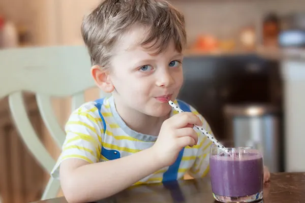Toddler boy drinking a banana-berry smoothie (with hidden veggies!)