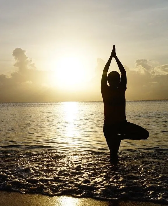 A woman balancing in the ocean – not necessarily the kind of "balance" moms need for their new year's resolutions!